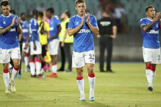The Rangers players applaud their fans at full time.