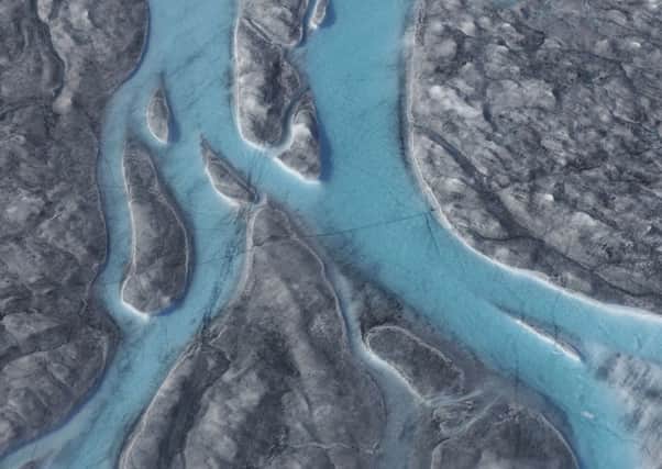 Large rivers of meltwater flow on an ice sheet in western Greenland on Thursday (Picture via Caspar Haarløv, Into the Ice, via AP)