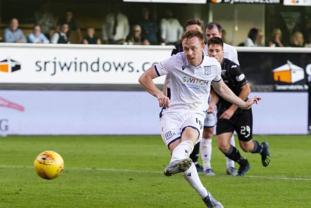 Danny Johnson converts his second penalty of the night to salvage a draw for Dundee at East End Park. Picture: Bruce White/SNS