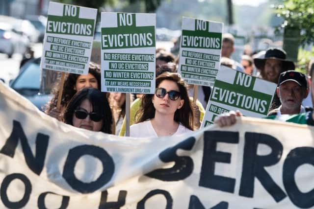 Protesters march on Serco offices in Glasgow last month where they put up a symbolic chain with padlocks. Picture: John Devlin