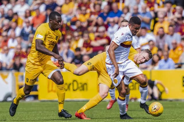 Livingston's Marvin Bartley (L) in action with Motherwell's Jermaine Hylton. Pic: SNS