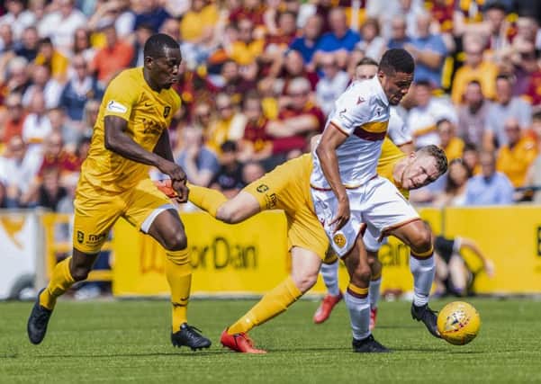 Livingston's Marvin Bartley (L) in action with Motherwell's Jermaine Hylton. Pic: SNS