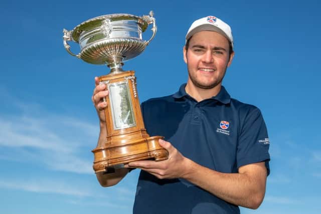 Crail member George Burns shows off the Scottish Amateur Championship trophy after his 19th-hole win over Kirkhills Lewis Irvine in the final. Picture: Kenny Smith