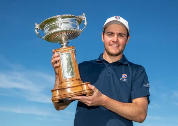 Crail member George Burns shows off the Scottish Amateur Championship trophy after his 19th-hole win over Kirkhills Lewis Irvine in the final. Picture: Kenny Smith
