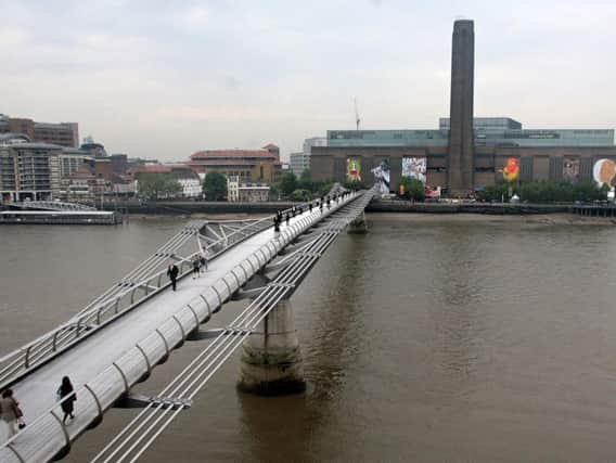 Teenager arrested after child "falls from height" at the Tate Modern in London.