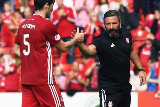 Derek McInnes (right) greets Scott McKenna after the 3-2 opening day win over Hearts