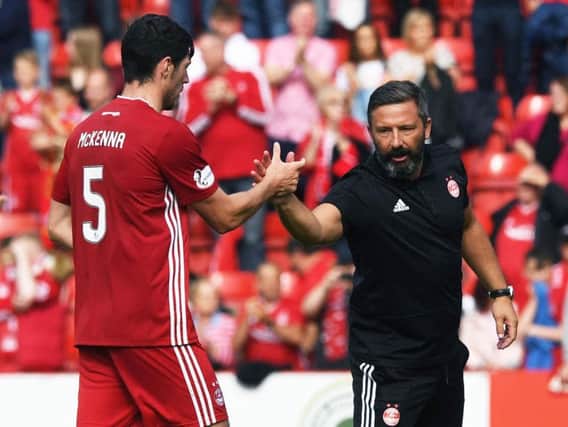 Derek McInnes (right) greets Scott McKenna after the 3-2 opening day win over Hearts