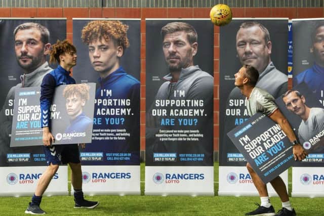 Rangers Nathan Young-Coombes, left, and coach Peter Lovenkrands where both on hand to help launch their Lotto campaign for the Rangers Youth Development Company.