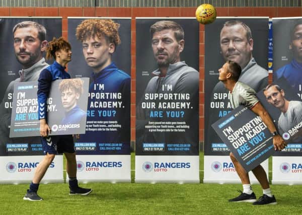Rangers Nathan Young-Coombes, left, and coach Peter Lovenkrands where both on hand to help launch their Lotto campaign for the Rangers Youth Development Company.