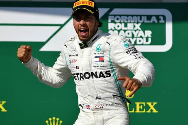 Lewis Hamilton celebrates on the podium after winning the Hungarian Grand Prix on Sunday. Picture: Getty.