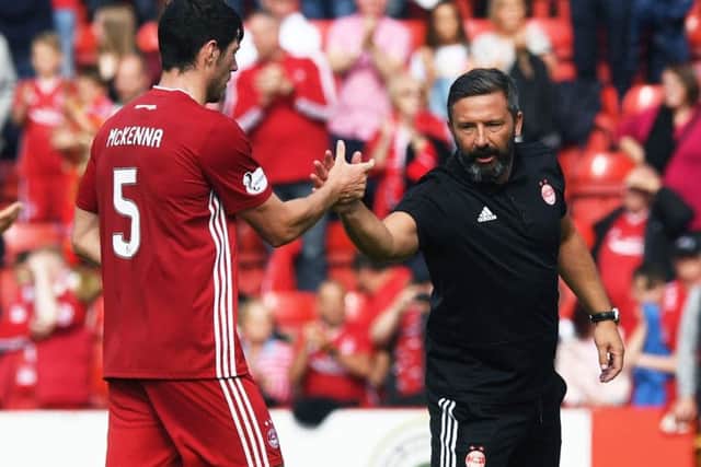 Aberdeens Scott McKenna and manager Derek McInnes celebrate at the end of their 3-2 win over Hearts at Pittodrie on Sunday. Picture: SNS.