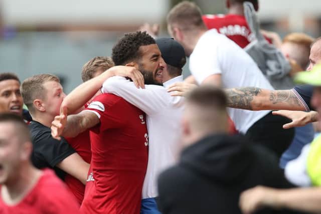 Connor Goldson is mobbed by fans after his late winner. Picture: Getty.