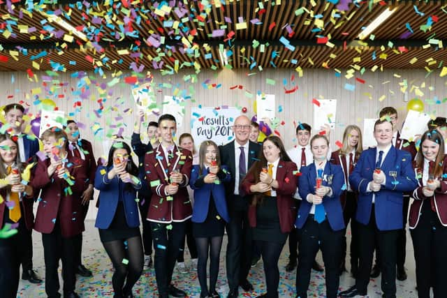 Scottish Education Secretary John Swinney with celebrating school pupils. Picture: PA