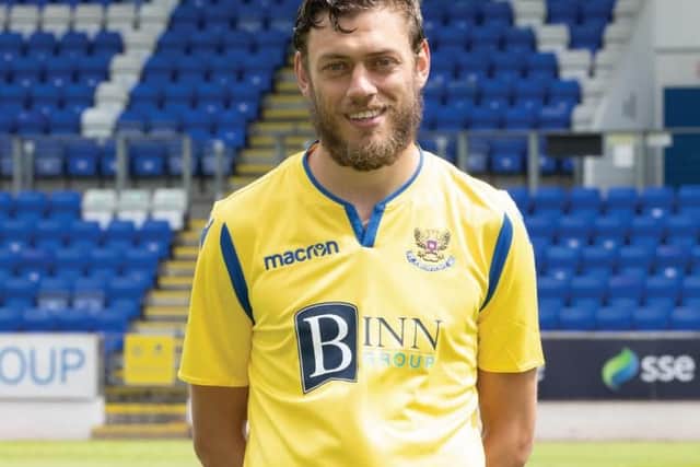 A top which is let down by both the fit and the sponsor.