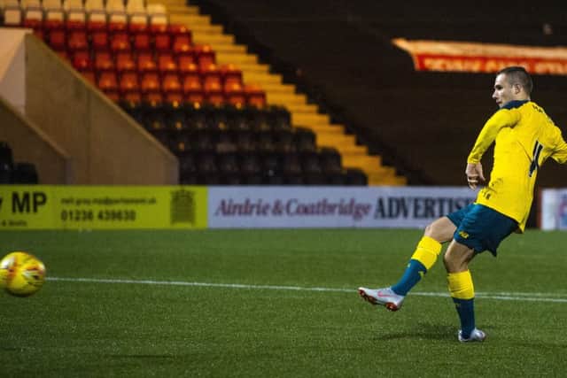 Liam Burt slots home the winning penalty for Celtic. Picture: SNS