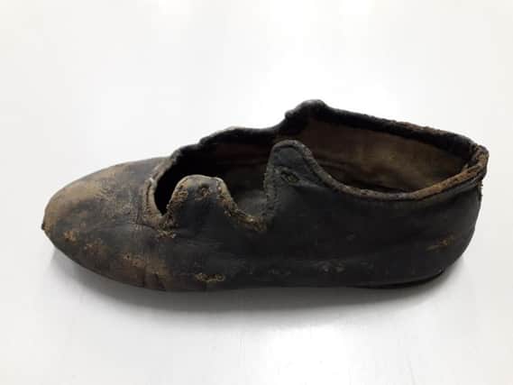 A childs leather shoe found by workmen in the roof of 5  7 Bristo Place, Edinburgh, during conversion work for the National Museums of Scotland. It dates from around 1810. PIC: NMS.