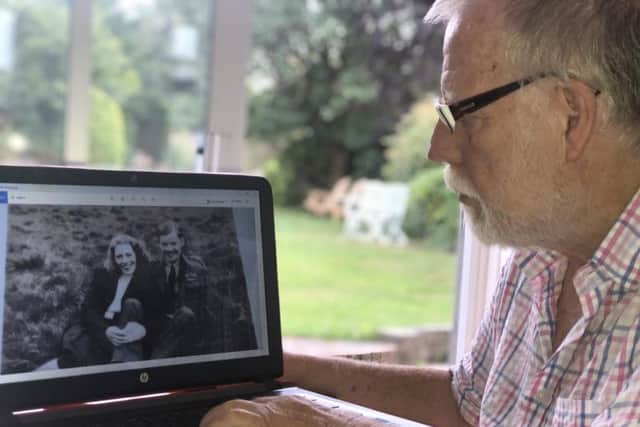 Mike Inkster looks at a photo of his mother Mary in WWII with John Lorimer, the man Mike believes is his real biological father. Picture: SWNS