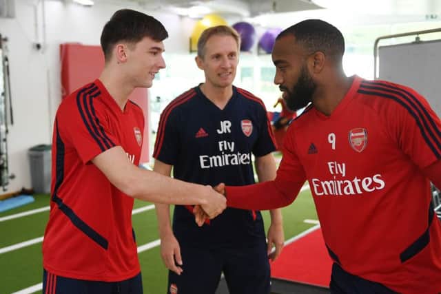 Kieran Tierney meets new team-mate Alexandre Lacazette. Picture: Stuart MacFarlane/Arsenal FC via Getty Images