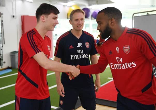 Kieran Tierney meets new team-mate Alexandre Lacazette. Picture: Stuart MacFarlane/Arsenal FC via Getty Images