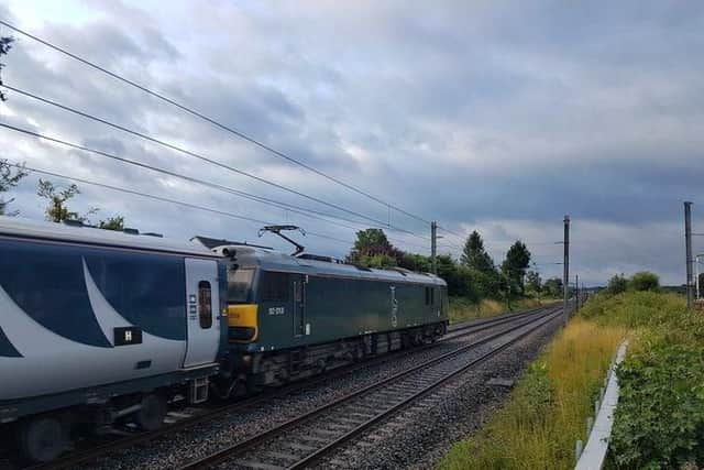 The broken down Caledonian Sleeper train is pictured here travelling very slowly south this morning after dumping passengers at Preston station