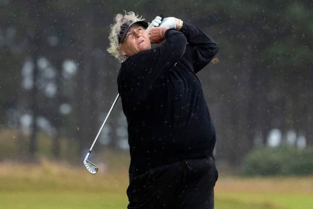 Laura Davies hits an iron shot on her way to a three-under-par 68 in the worst of the weather. Picture: Kenny Smith.