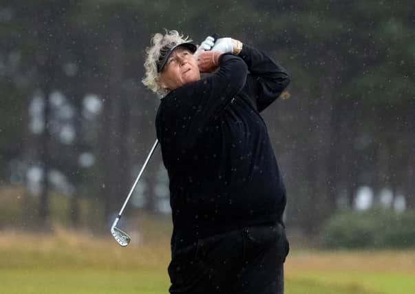 Laura Davies hits an iron shot on her way to a three-under-par 68 in the worst of the weather. Picture: Kenny Smith.
