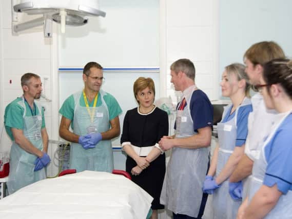 Nicola Sturgeon on a visit to Ninewells Hospital in Dundee. The Scottish Government said it would fully consider the issues raised in the report (Photo: PA)