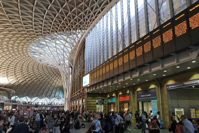 People wait inside London King's Cross Station as all trains were suspended. Picture: PA