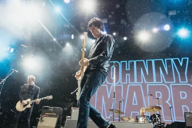 Johnny Marr continued with his set after a short break due to the weather.