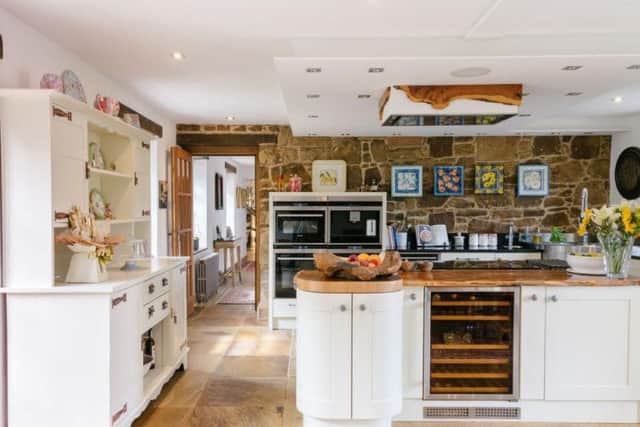 The open plan kitchen has a mix of modern and traditional styles.