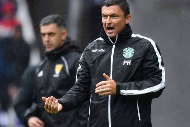 The rain clouds gathered over Hibs manager Paul Heckingbottom in Sundays heavy defeat by Rangers. Picture: SNS.