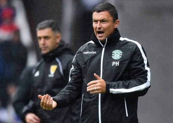 The rain clouds gathered over Hibs manager Paul Heckingbottom in Sundays heavy defeat by Rangers. Picture: SNS.