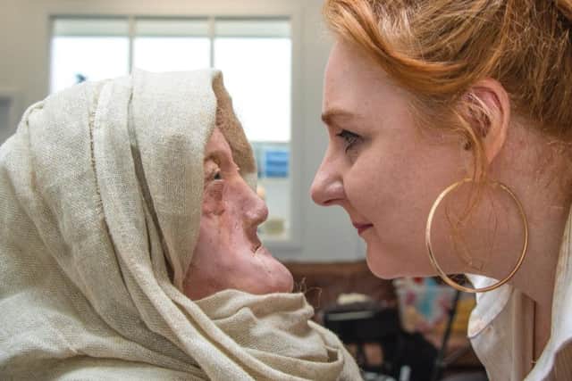 Karen Fleming and the wax head of the toothless druid from Lewis. PIC: University of Dundee.