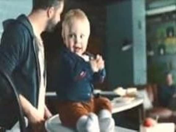 The advert showed two new fathers leaving a baby on a restaurant conveyor belt.