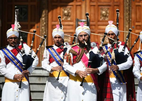 The Sri Dasmesh Pipe Band, a Malaysian Sikh Band, tunes up outside the Gurdwara Singh Sabah temple in Glasgow ahead of their performances at Pipping Live! and the World Pipe Band Championships PIC: John Devlin