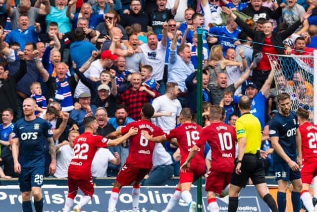 Rangers fans celebrate in the away end at Rugby Park after Connor Goldson's late winner.