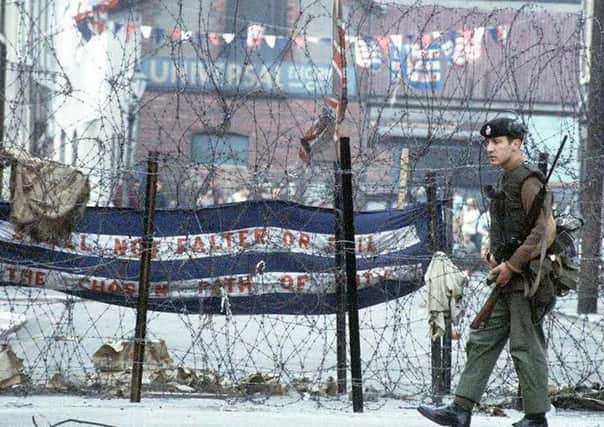 A soldier patrolling the troubled Falls Road area of Belfast in 1969. Picture: PA
