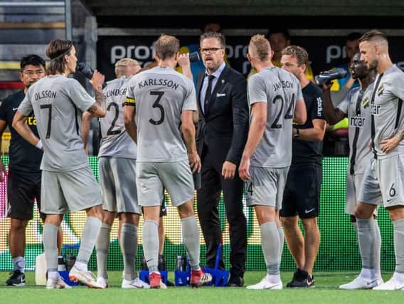 Manager Rikard Norling speaks to his AIK players during a Europe League qualifier.