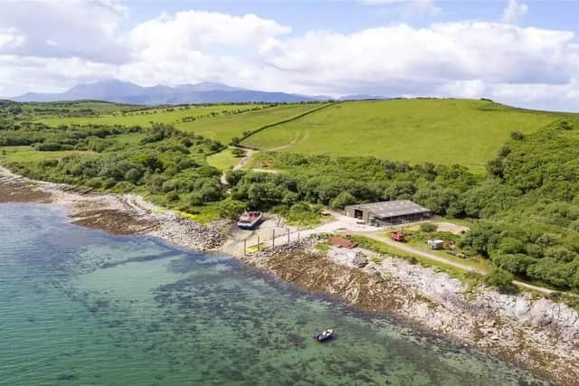 Beside the house and overlooking the concrete slipway, is a garage/boat shed/workshop.