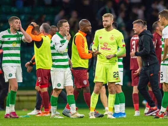 Scott Bain (centre right), Callum McGregor and Ryan Christie look dejected after the final whistle against Cluj