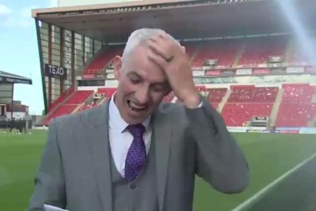 Chris Harvey wipes water from his head and continues with the live broadcast