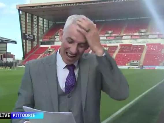 Chris Harvey wipes water from his head and continues with the live broadcast