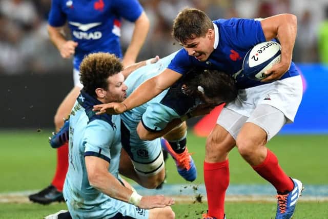Scotland centre Duncan Taylor gets to grips with France's scrum-half Antoine Dupont. Picture: Pascal Guyot/AFP
