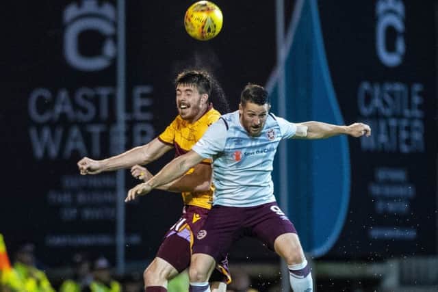 Striker Conor Washington, right, vies with Motherwells Declan Gallagher during a morale-boosting win for Hearts. Picture: SNS.