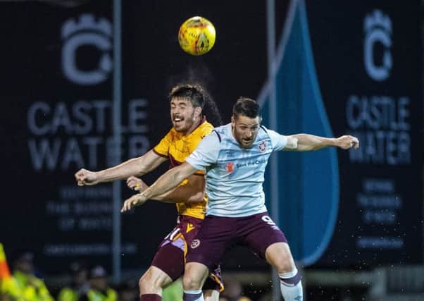 Striker Conor Washington, right, vies with Motherwells Declan Gallagher during a morale-boosting win for Hearts. Picture: SNS.