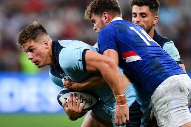 Scotland centre Huw Jones is tackled by France wing Damian Penaud as Adam Hastings looks on. Picture: Pascal Guyot/AFP/Getty Images