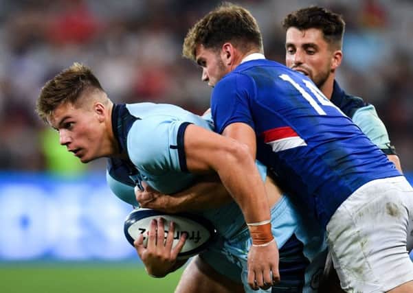 Scotland centre Huw Jones is tackled by France wing Damian Penaud as Adam Hastings looks on. Picture: Pascal Guyot/AFP/Getty Images