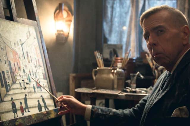 Spall as LS Lowry, painting his Salford scenes at night after his mother was asleep