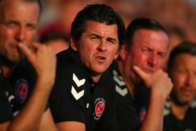 Fleetwood Town boss Joey Barton watches on from the dugout