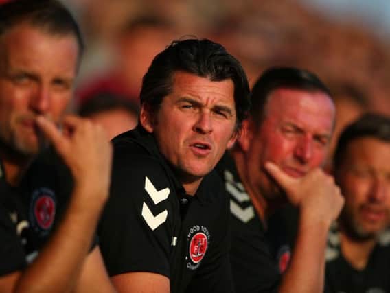 Fleetwood Town boss Joey Barton watches on from the dugout